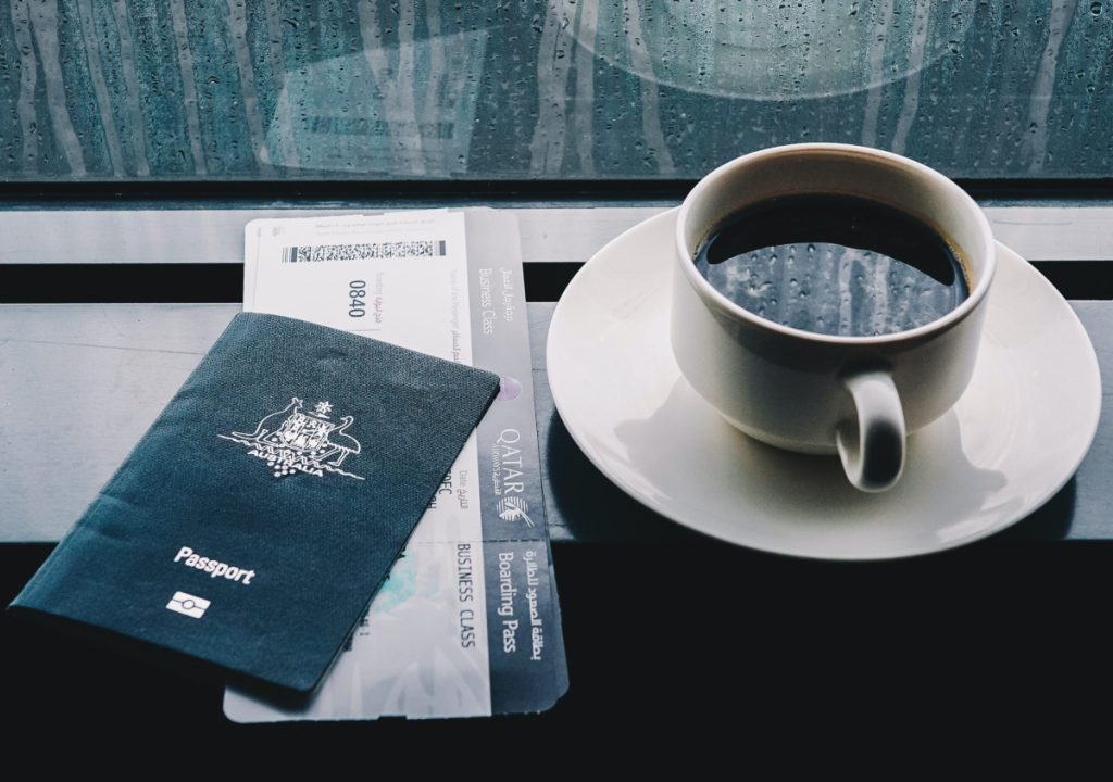 Business Class ticket, passport and coffee